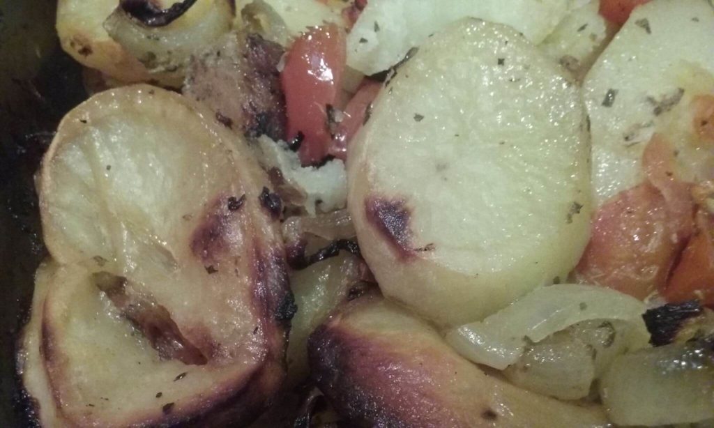 Traditional Cypriot Pork Tavas with slow-baked potatoes and onions.