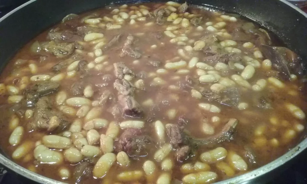 Braised lamb with white beans — slow braised lamb ribs and alubia beans in a rich tomato and red wine sauce