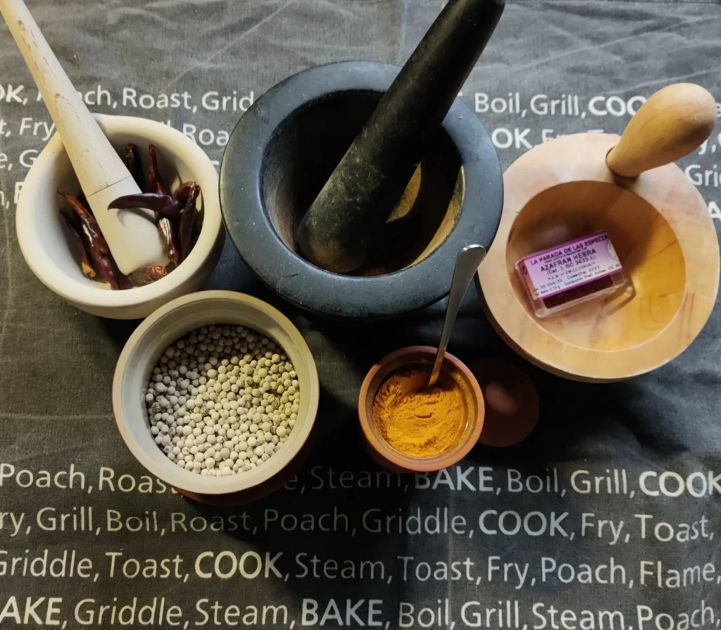 Homemade biryani masala recipe — whole spices ready for toasting and grinding in a pestle and mortar