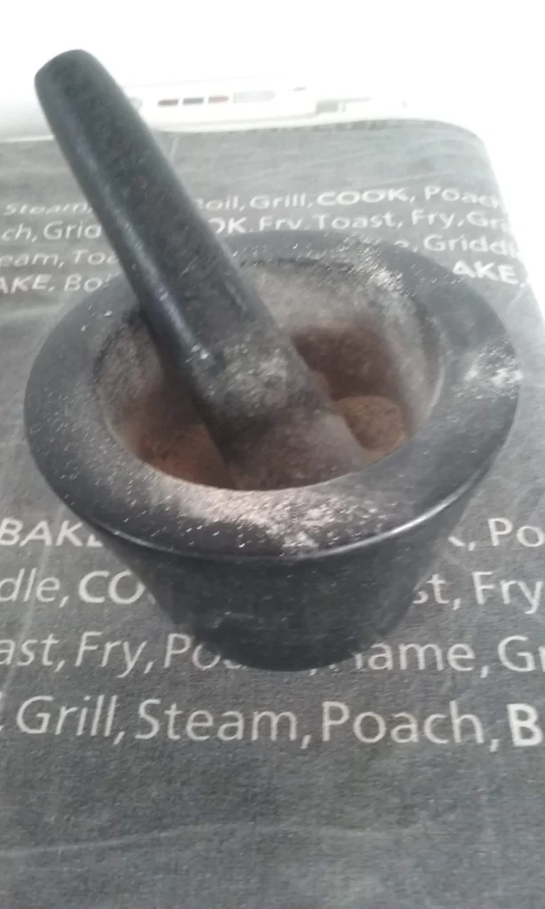 Homemade malgapodi gun powder spice blend in a black granite pestle and mortar at Casa Adora