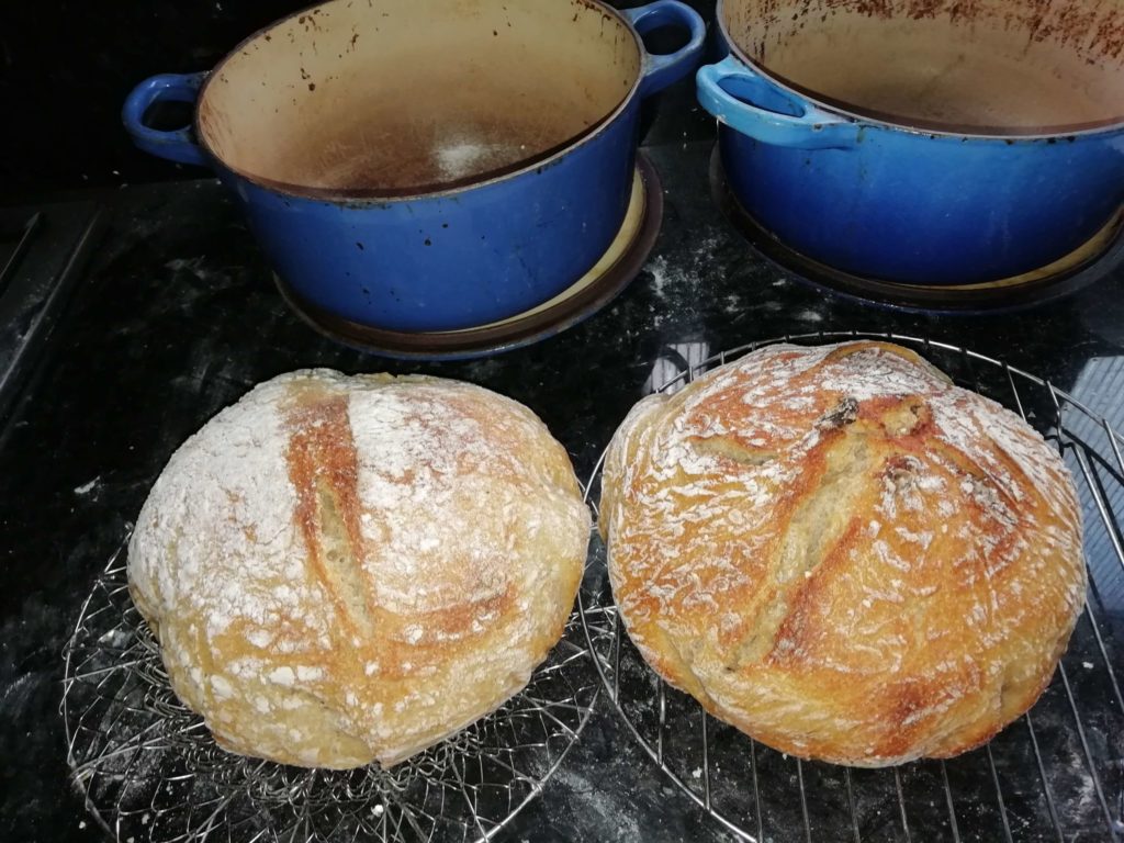 Two golden sourdough loaves cooling on a wire rack — easy sourdough bread — The Flexible Chef