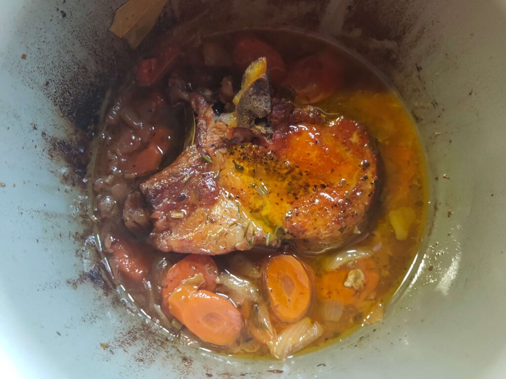 A tender Slow Cooker Pork Chop served with seasonal vegetables at Casa Adora.