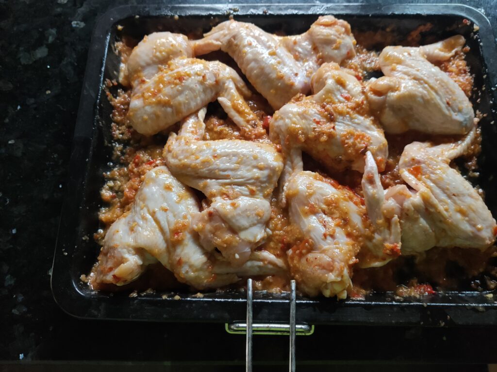 RidgeMonkey spicy chicken wings cooked on a van life gas hob — The Flexible Chef