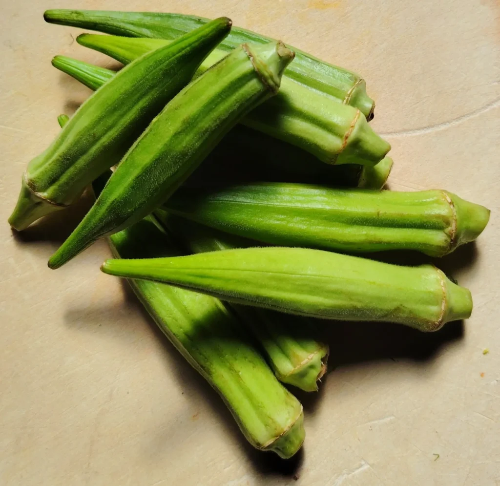 Fresh okra pods on a wooden board – how to cook fresh okra – The Flexible Chef