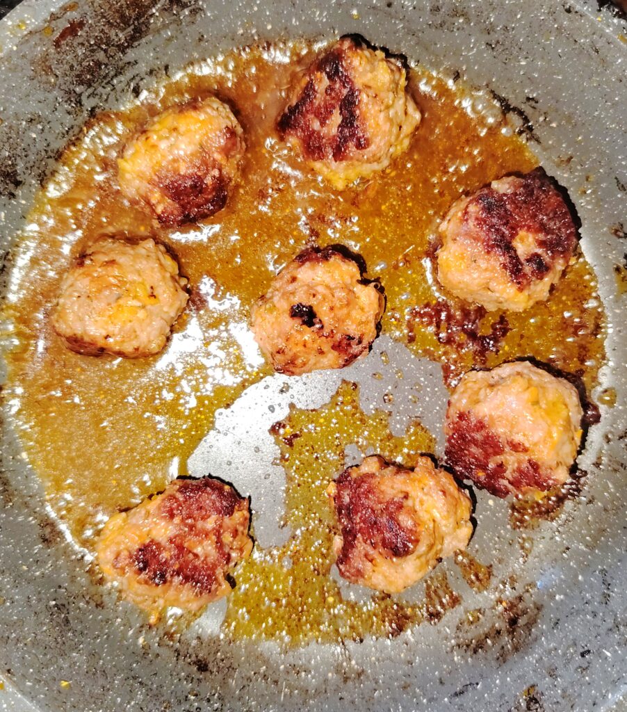 Lazy Parmesan beef meatballs simmering in a quick tomato sauce in a frying pan — lazy Parmesan beef meatballs — The Flexible Chef
