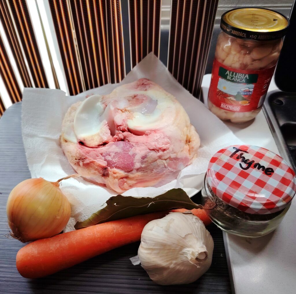 Osso buco with white beans and lemon zest simmered in chicken stock — a one-pan campervan recipe