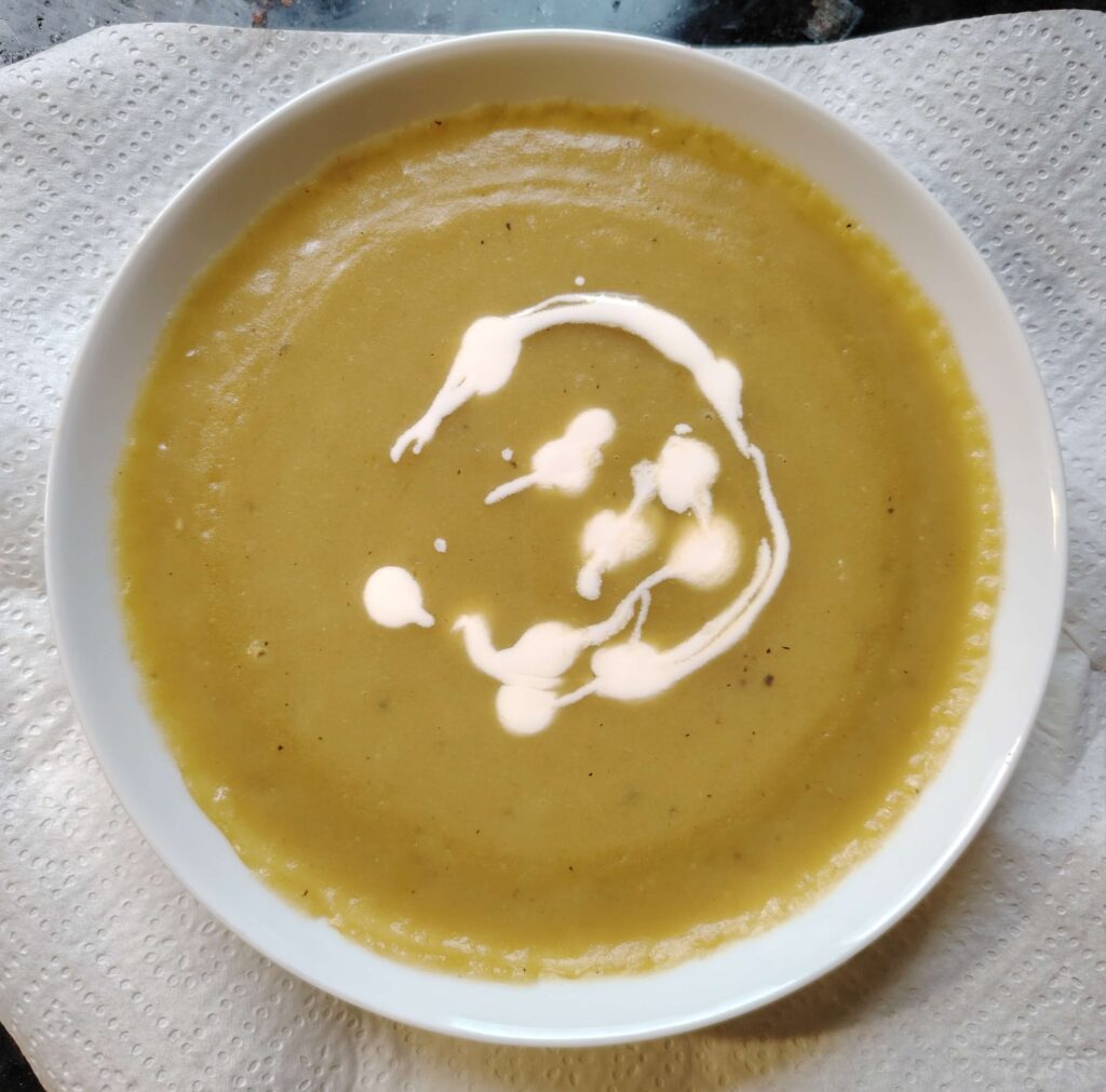 Pepper soup in a bowl with a swirl of cream