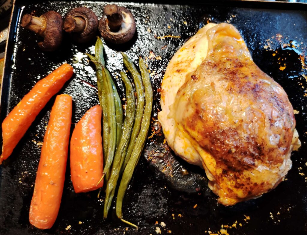 Close-up of crispy roasted chicken breast stuffed with herby chicken sausage and paprika