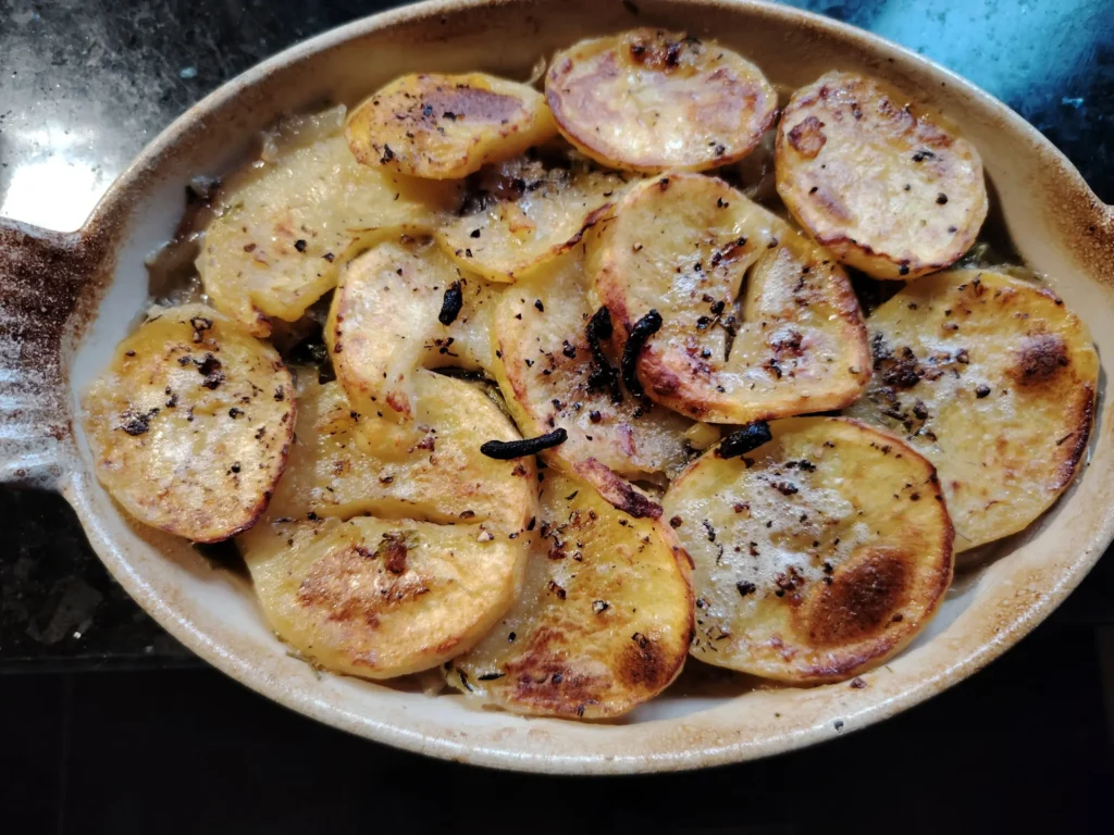 Potato onion garlic gratin with chicken broth in a ceramic ovenproof dish at Casa Adora