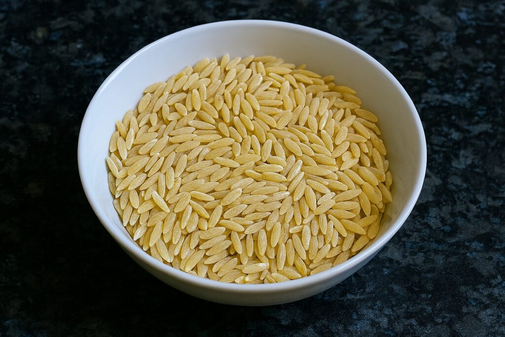 A bowl of uncooked orzo on the worktop — roasted cauliflower orzo — The Flexible Chef