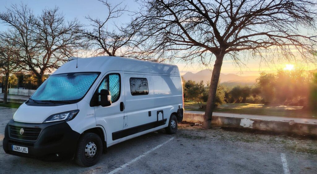 Fiat Ducato campervan parked at a free park up in Torredonjimeno, Andalucía, at sunrise among olive groves