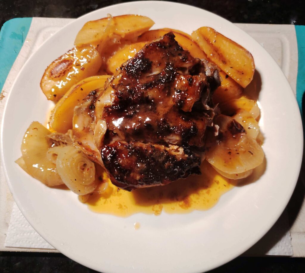 Slow roasted Greek lamb shoulder served with golden roasted potatoes and caramelised onions