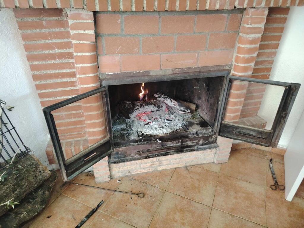 Wood-fired insert burning in Rafa's almacén in a rural Andalusian village in Spain