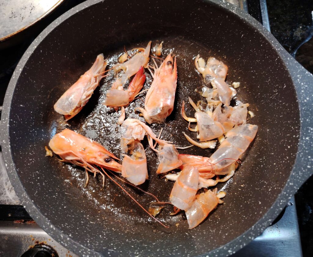 Langoustine shells and heads toasting in a pan for shell stock β hake langoustine stew β The Flexible Chef