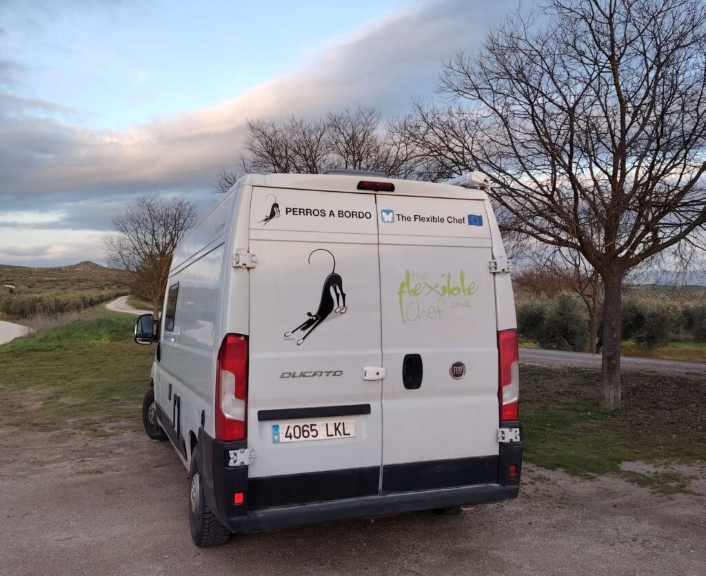 The Flexible Chef Fiat Ducato campervan parked on a rural road in Spain at dusk
