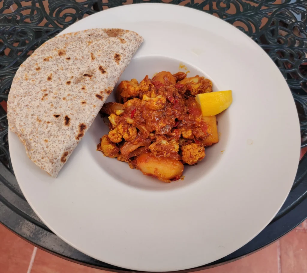 Aloo gobi recipe – dry sabzi style potato and cauliflower curry served with wholemeal tortilla and lemon