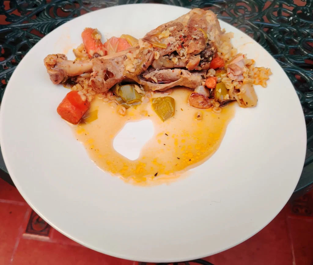 Braised turkey leg with barley, carrots and leeks on a white plate — braised turkey leg recipe — The Flexible Chef