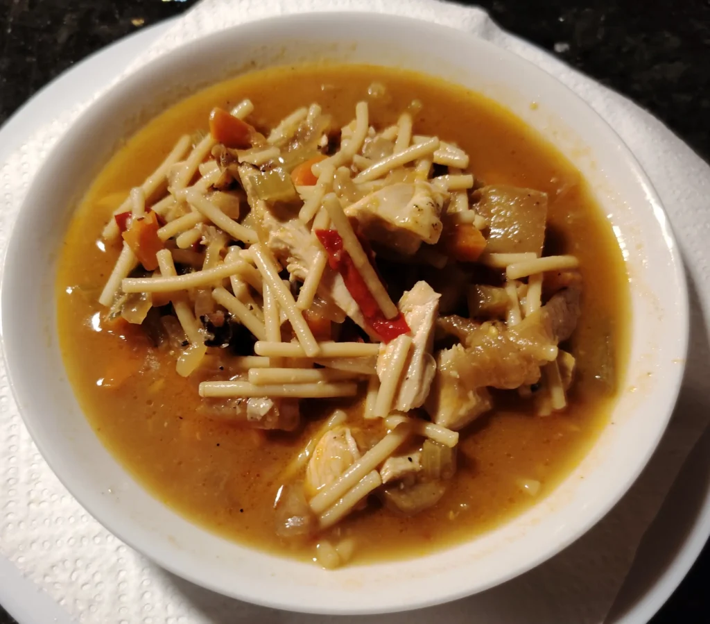 Leftover chicken noodle soup with fideo, red pepper and mushroom