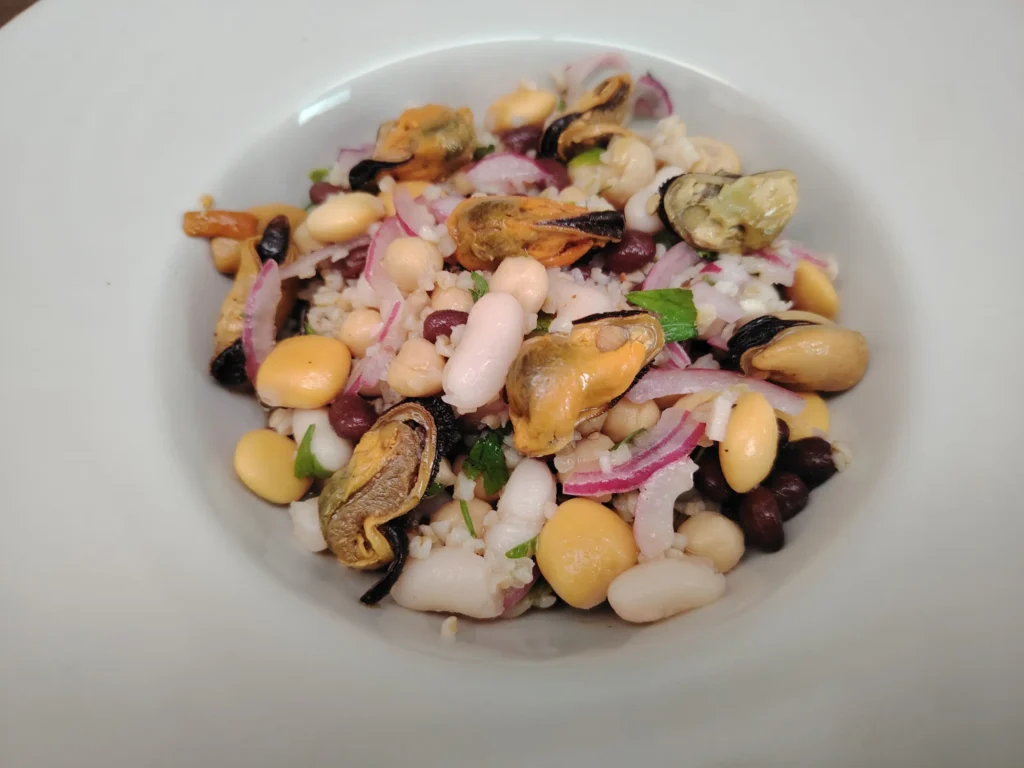 Four bean salad with mussels and bulgur wheat in a white bowl — white beans, black beans, chickpeas, altramuces and tinned mussels, Casa Adora
