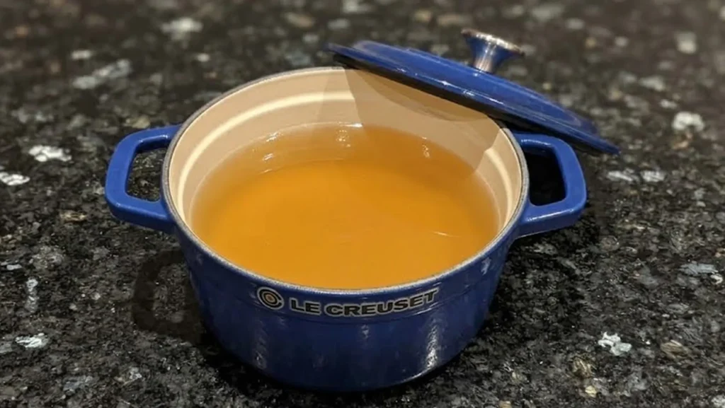 Homemade vegetable stock in a blue Le Creuset pot – vegetable stock recipe – The Flexible Chef